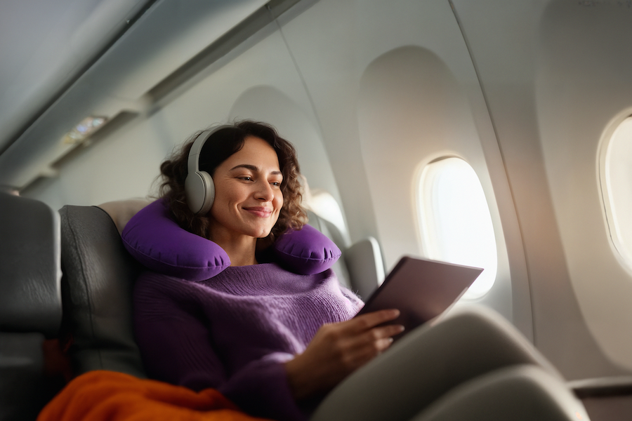 2. woman reading an ipad on an airplane